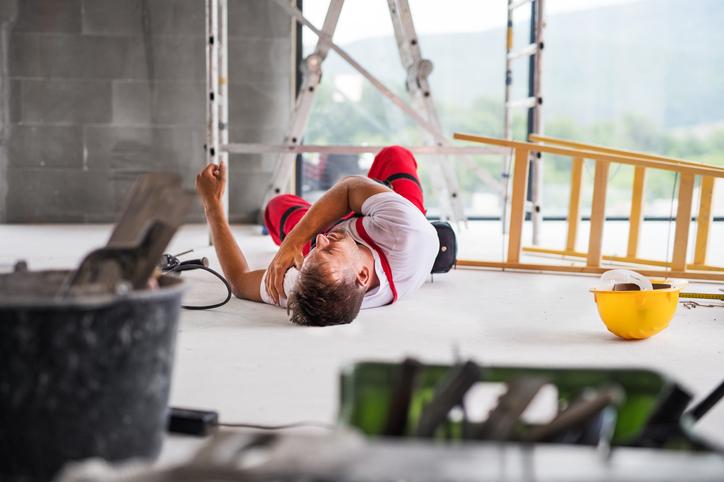 Injury at work Man fallen down from ladder at work with injury