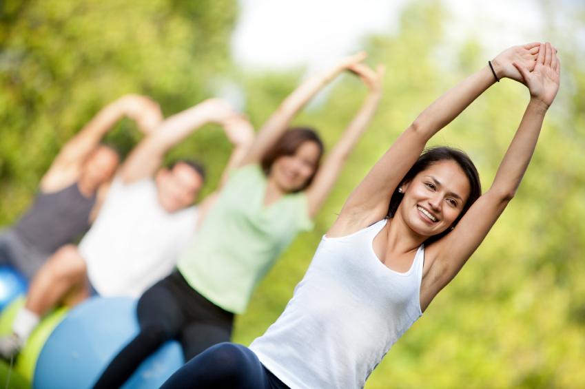 Group of people doing pilates with exercise ball Group of people doing pilates with exercise ball